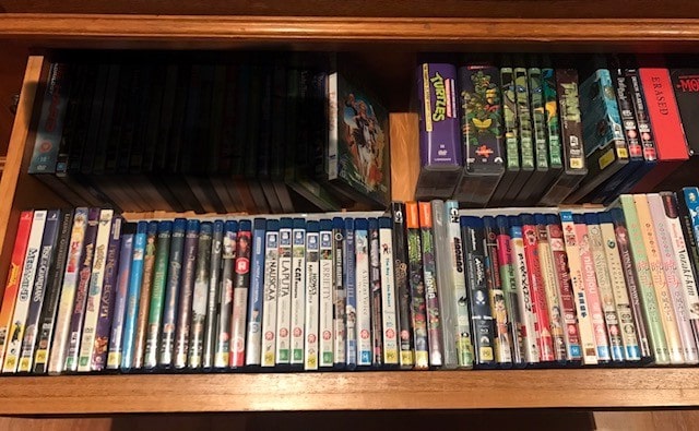 collection of dvds and blu rays in a drawer